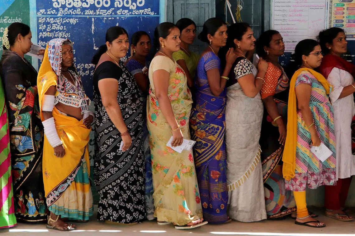 Women queueing to cast their votes at a polling station in the southern Indian state of Telangana on May 13.