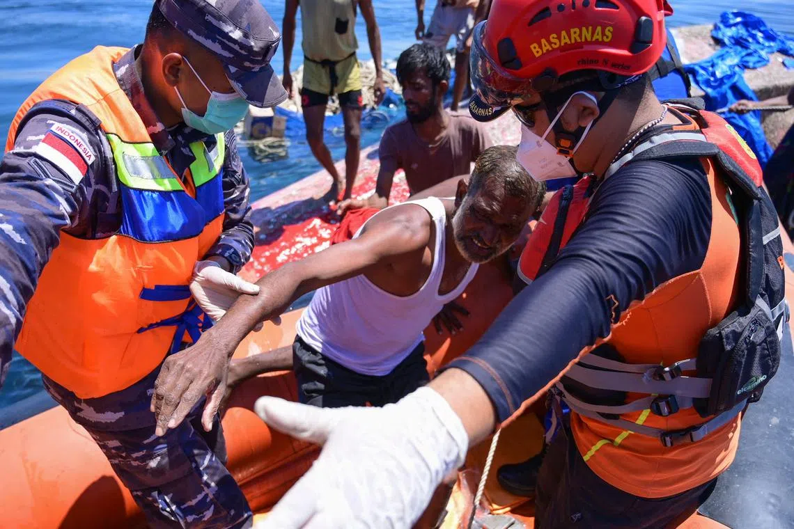 A Rohingya refugee is rescued from their capsized boat by Indonesian rescuers some 16 nautical miles off western Aceh on March 21.