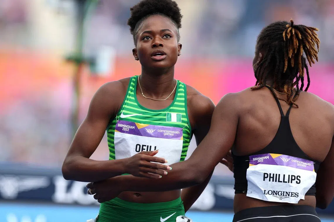 FILE PHOTO: Commonwealth Games - Athletics - Women's 200m - Heats - Alexander Stadium, Birmingham, Britain - August 4, 2022 Nigeria's Favour Ofili and Guyana's Kenisha Phillips react after their heat REUTERS/Phil Noble/File Photo