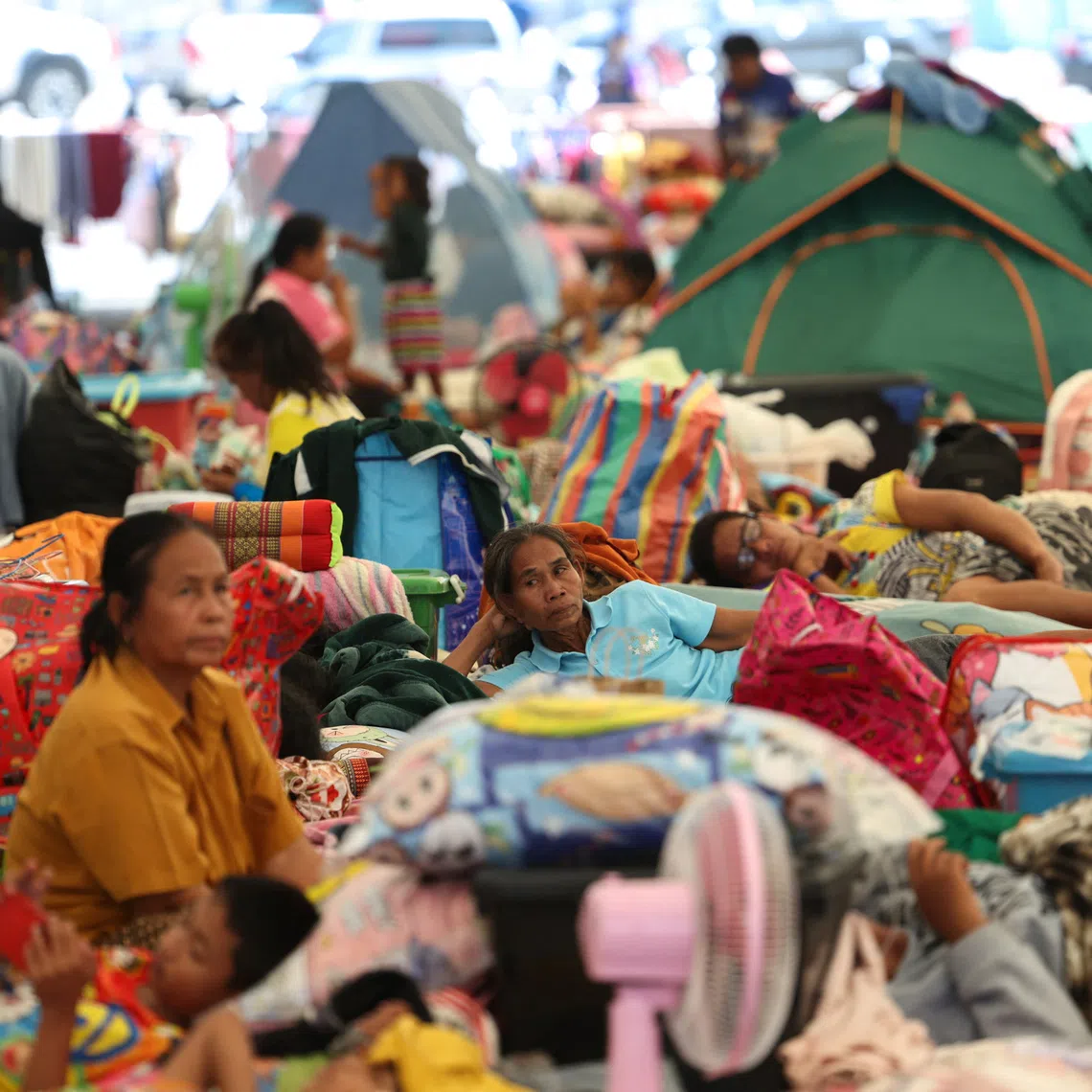 Displaced people gather inside a temporary shelter amid deadly clashes between Thailand and Cambodia, Dec 9, 2025.