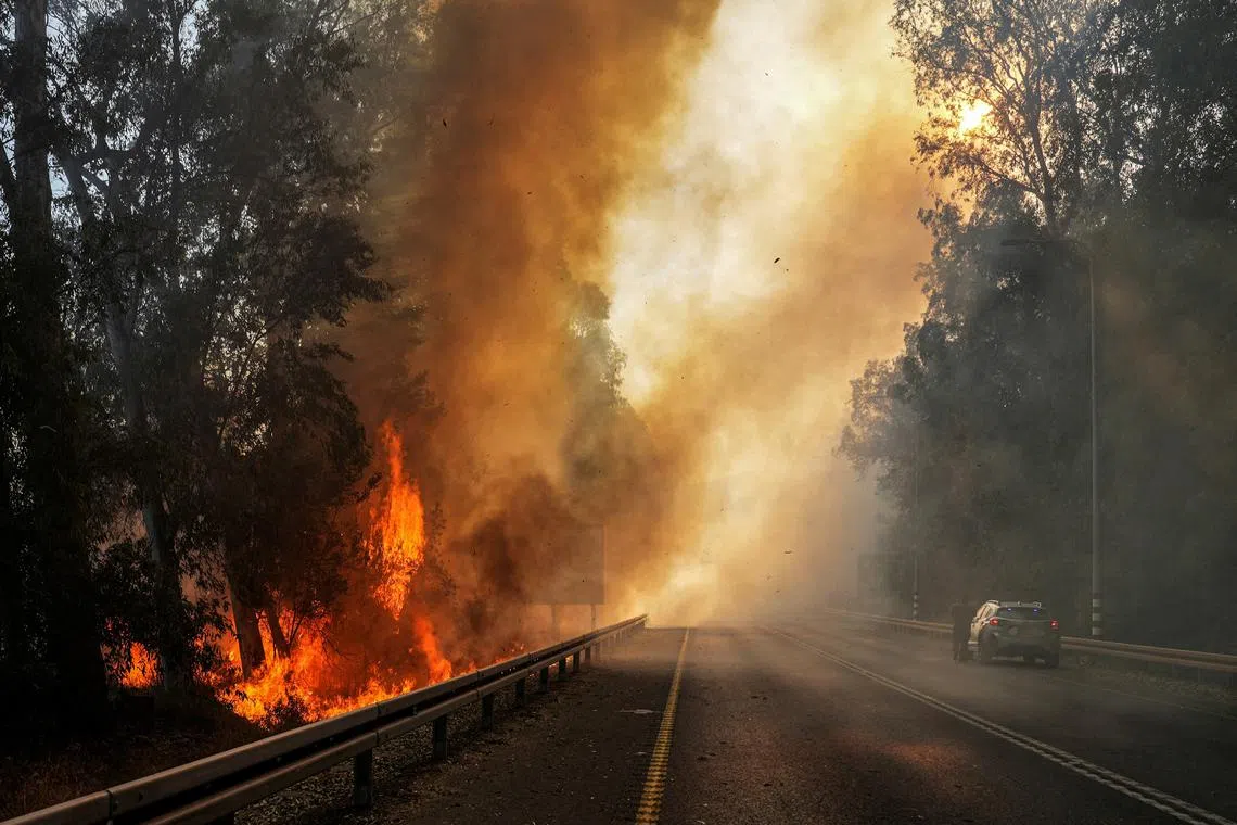 Flames seen at the side of a road, amid ongoing cross-border hostilities between Hezbollah and Israeli forces, close to the Israel border with Lebanon, in northern Israel, June 4, 2024. REUTERS/Ayal Margolin