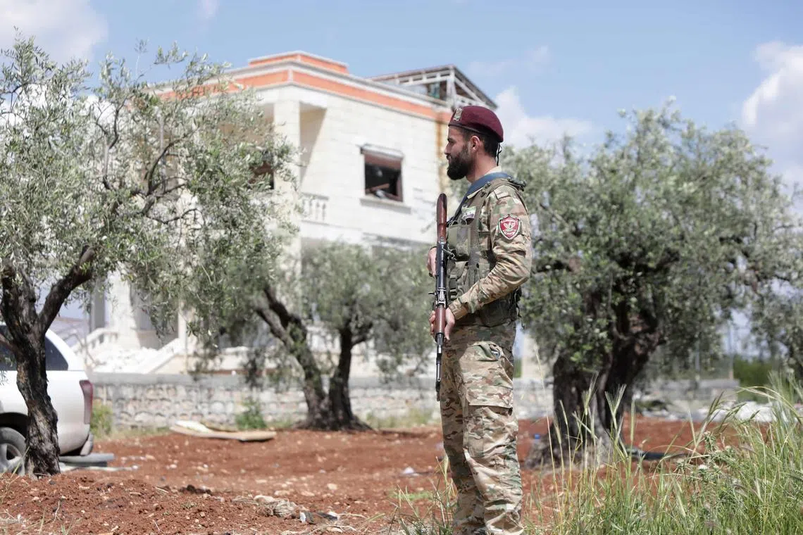 A member of the Turkish-backed military police stands guard outside a house in Syria reportedly used by the ISIS chief.