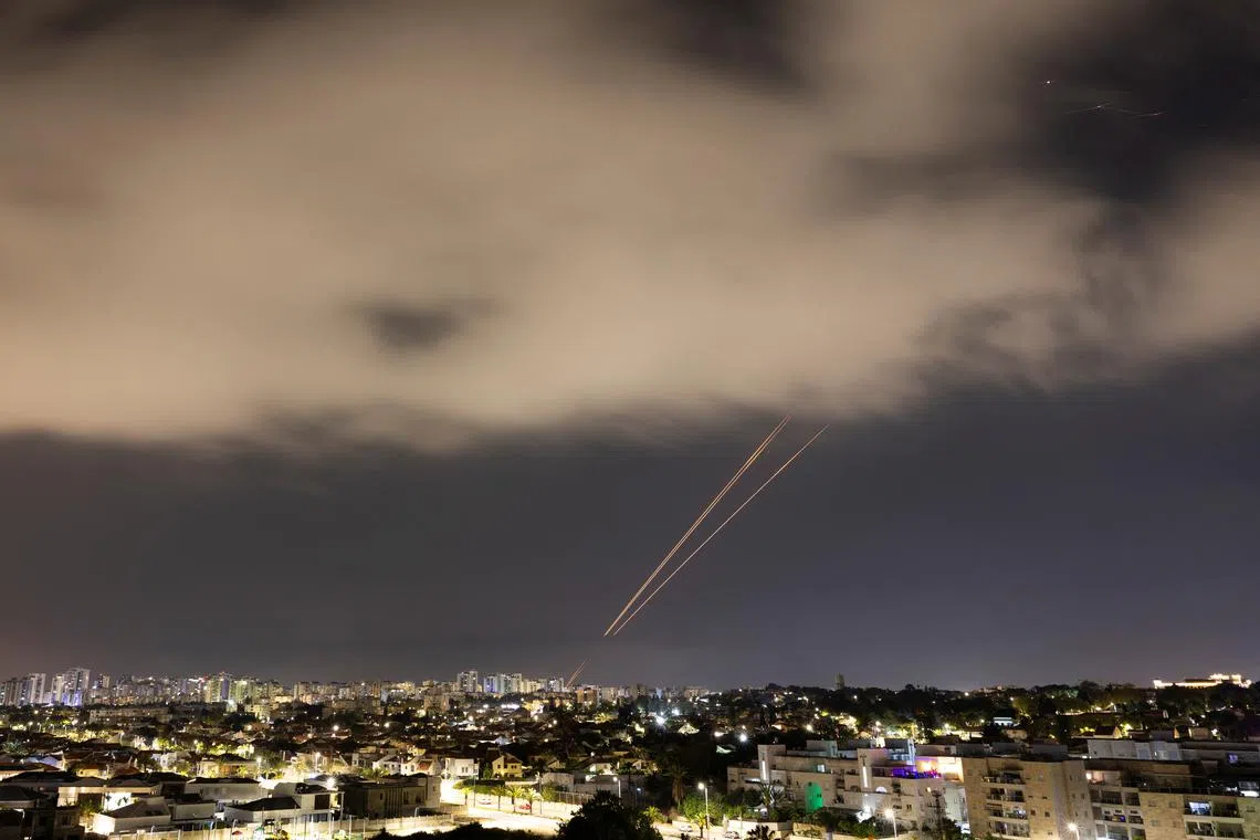 Objects are intercepted in the sky after Iran launched drones and missiles towards Israel, as seen from Ashkelon, Israel April 14, 2024.