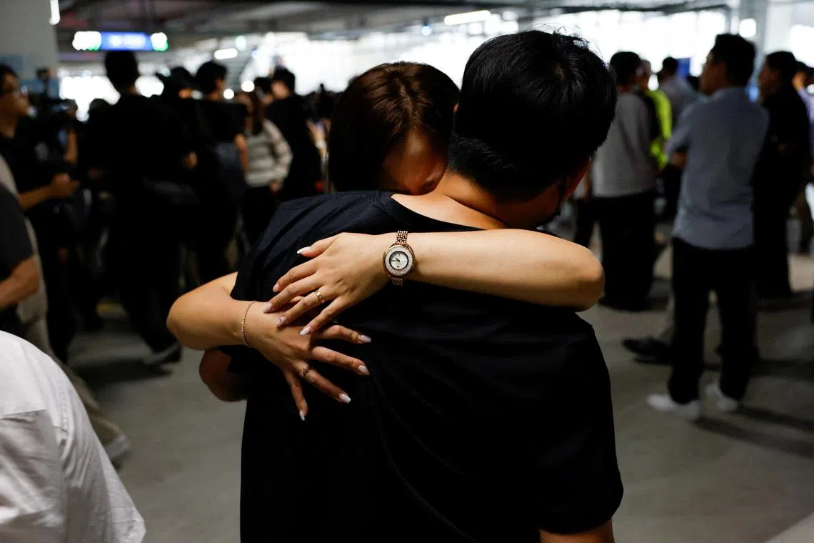 A South Korean worker who was detained in a huge immigration raid last week at the site of a U.S. car battery project involving Hyundai Motor and LG Energy Solution in the U.S. state of Georgia, hugs a family member in the long term parking lot at the Incheon International Airport in Incheon, South Korea, September 12, 2025. REUTERS/Kim Soo-hyeon