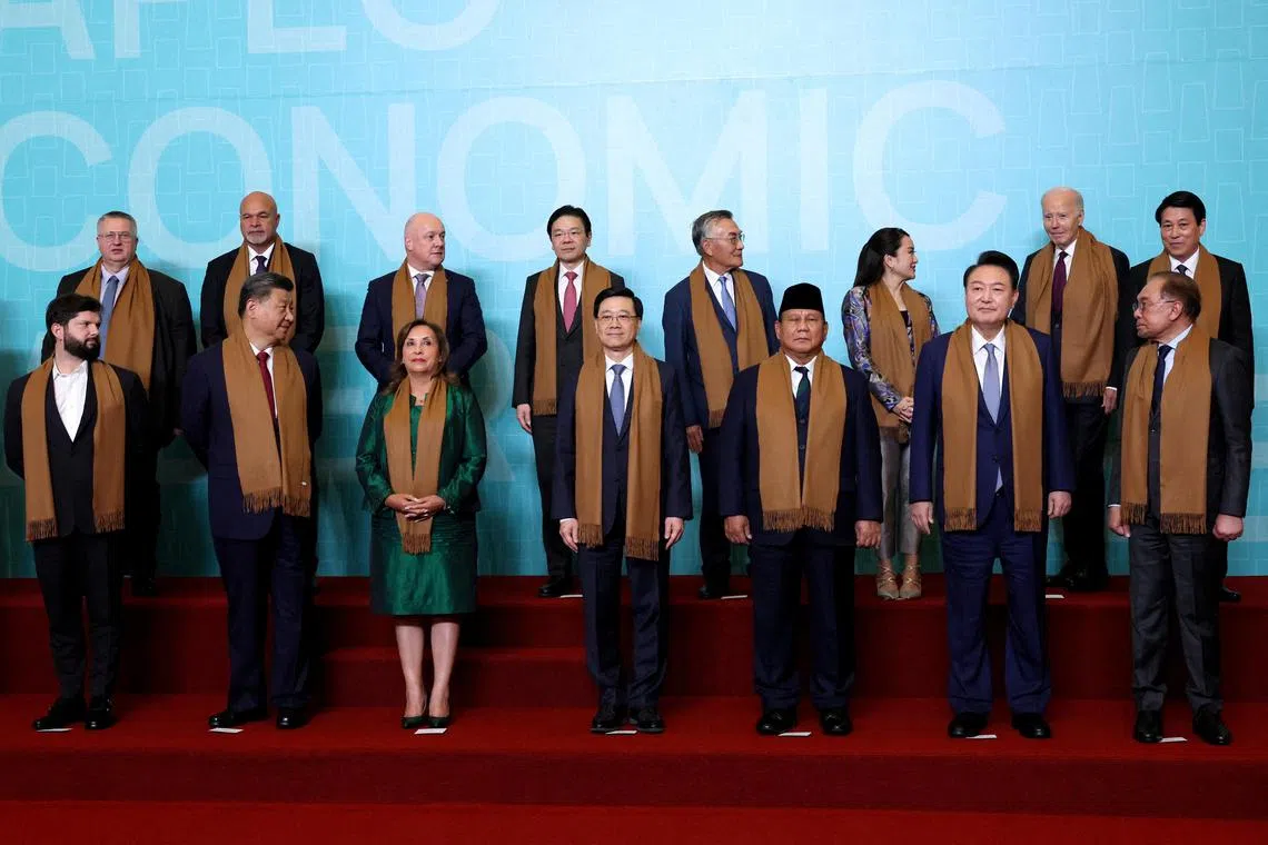 Chinese President Xi Jinping (front row, second from left) and US President Joe Biden (back row, second from right) join other leaders for the Apec summit family photo.