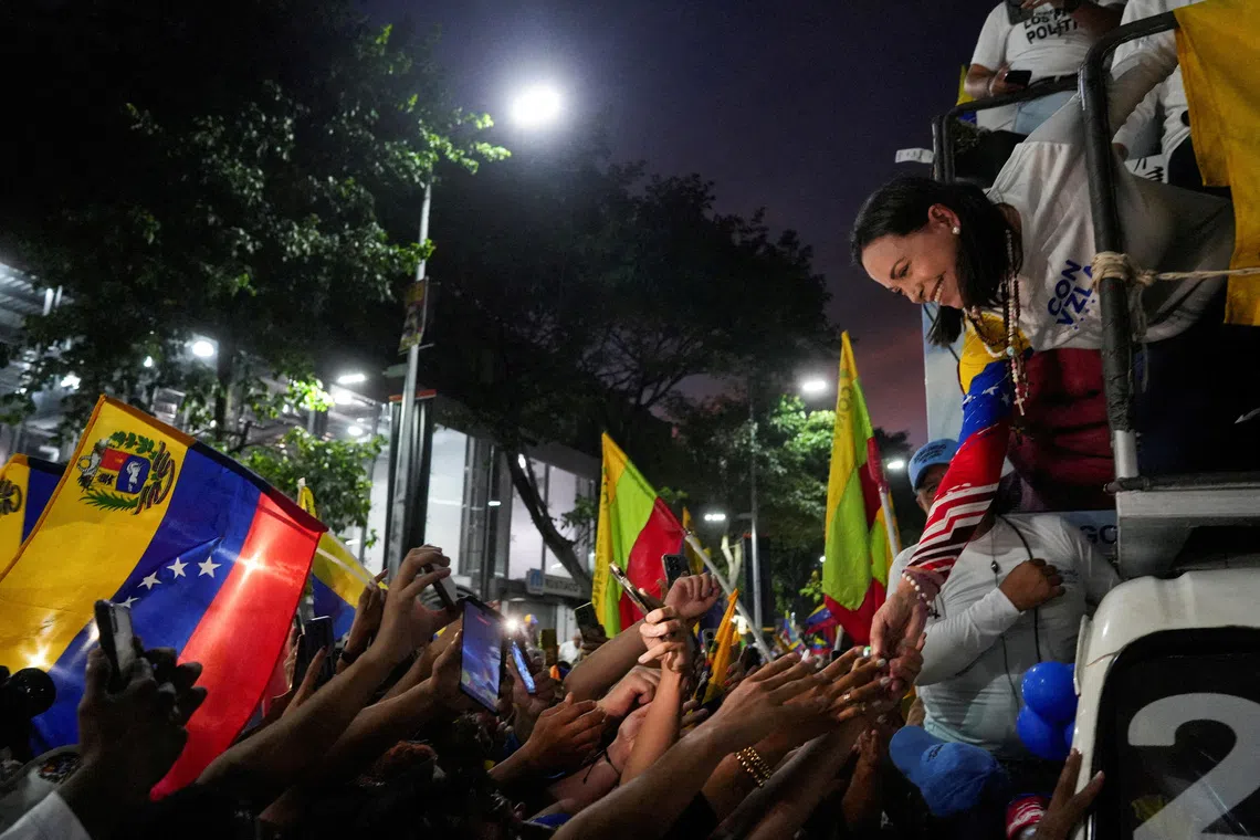 FILE PHOTO: Venezuelan opposition leader Maria Corina Machado greets supporters during a presidential election campaign closing rally in Caracas, Venezuela, July 25, 2024. REUTERS/Alexandre Meneghini/File Photo