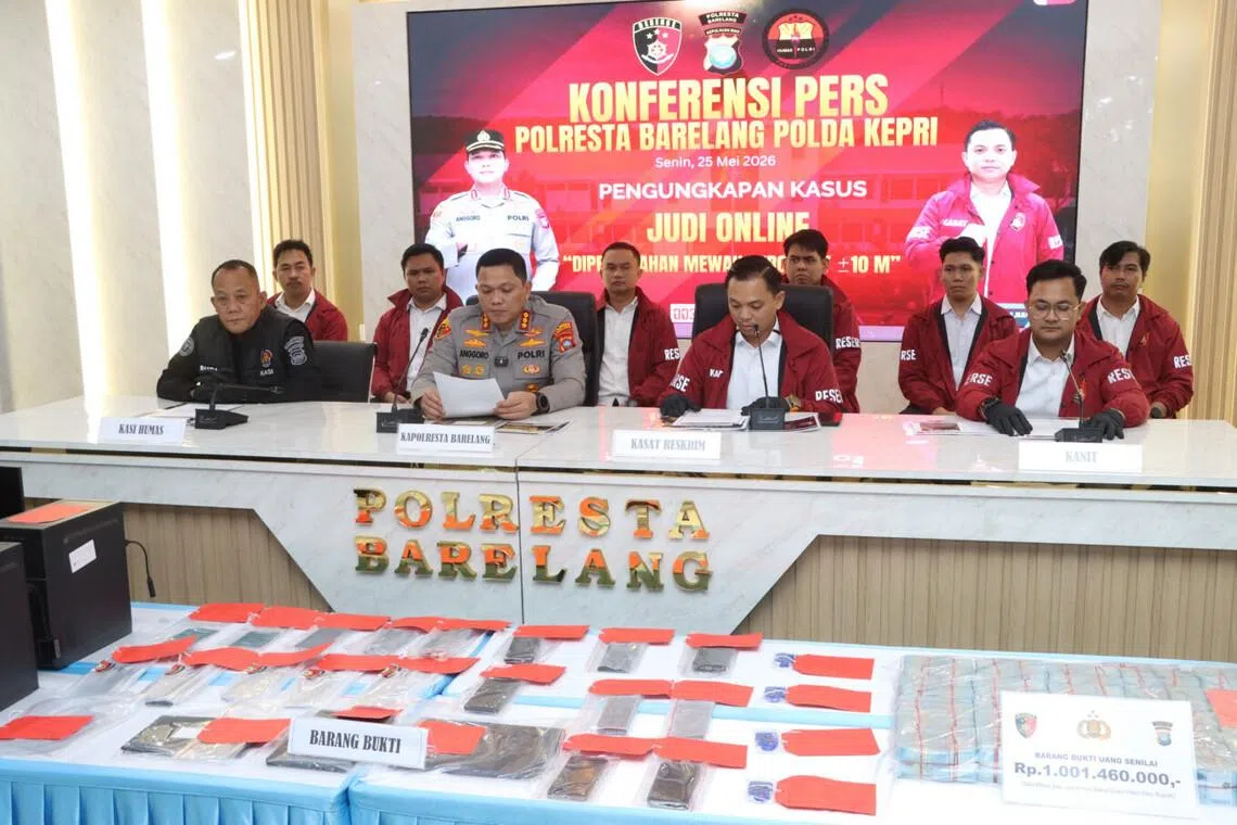 Batam, Rempang and Galang Police chief Anggoro Wicaksono reads a statement on May 25, 2026, during a press conference in Batam on a raid that dismantled the Indonesian branch of an multinational gambling network in the Riau Islands city.

