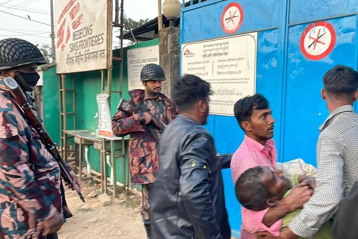 Local people carry a wounded man for emergency treatment at a MSF facility on Feb 4.