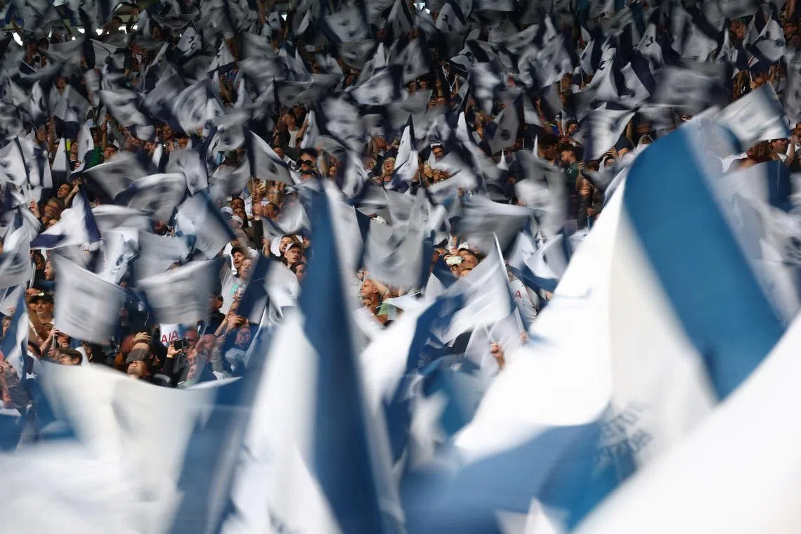 FILE PHOTO: Soccer Football - Premier League - Tottenham Hotspur v Brighton & Hove Albion - Tottenham Hotspur Stadium, London, Britain - May 25, 2025 Tottenham Hotspur fans waving flags inside the stadium Action Images via Reuters/Matthew Childs/File Photo