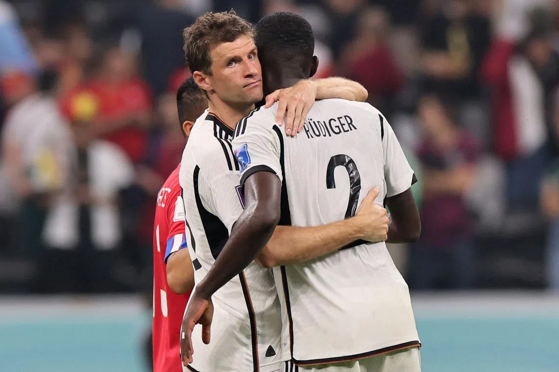 Germany's Thomas Mueller (left) consoles defender Antonio Ruediger after the team failed to qualify.