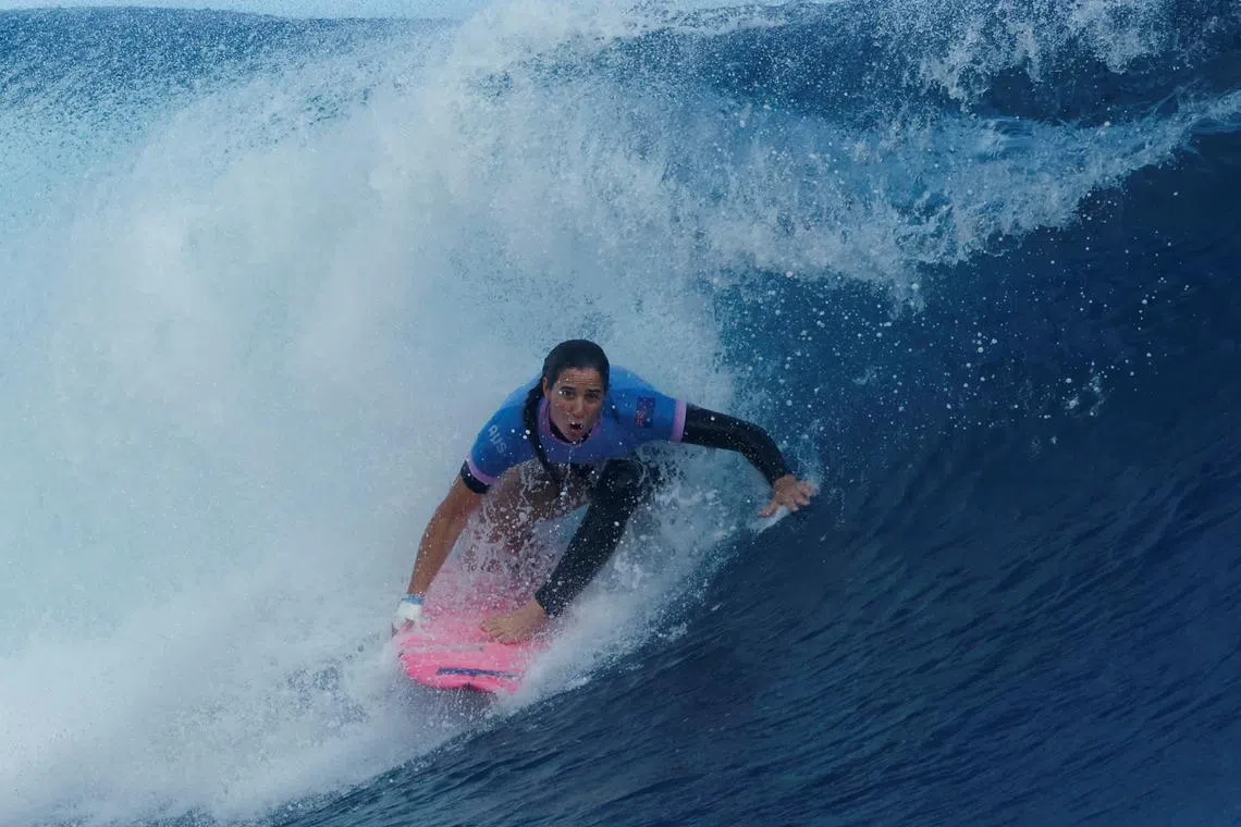 FILE PHOTO: Paris 2024 Olympics - Surfing - Women's Quarterfinals - Heat 1 - Teahupo'o, Tahiti, French Polynesia  - August 01, 2024. Tyler Wright of Australia rides a wave. Ben Thouard/Pool via REUTERS/File Photo
