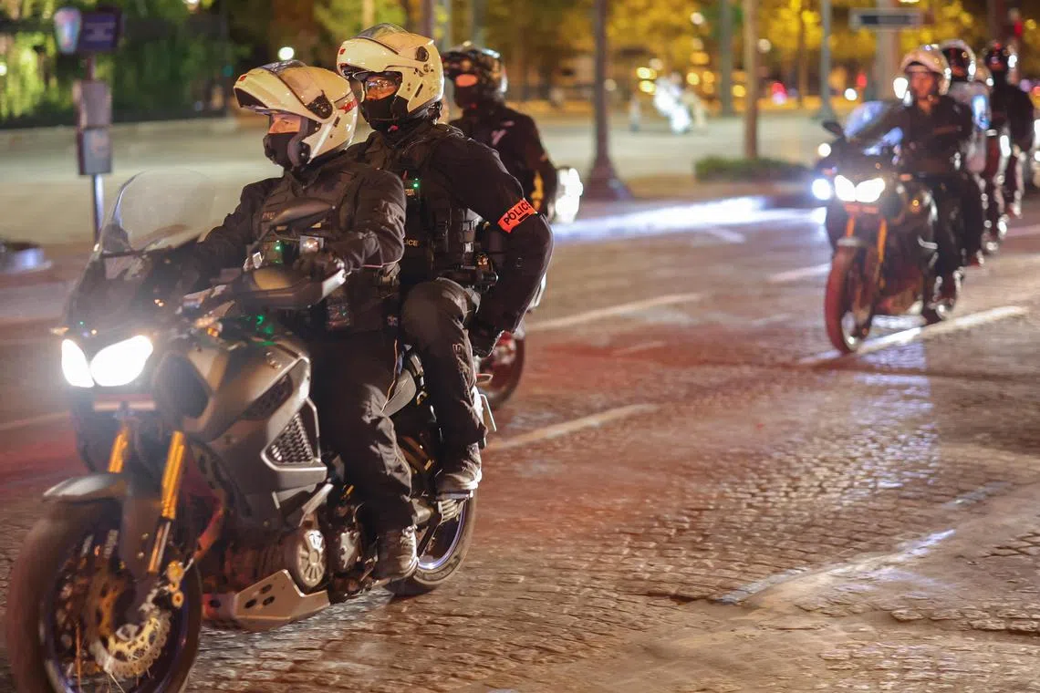 Riot police forces on motorbike secure the area in front of the Arc de triomphe amid fears of another night of clashes with protestors in Paris.