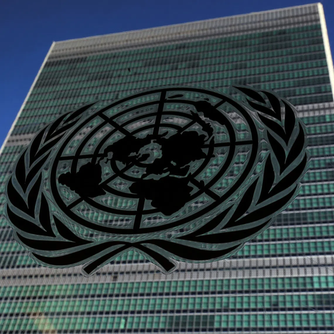 FILE PHOTO: The United Nations logo is pictured in front of the United Nations Headquarters building during the 71st United Nations General Assembly in the Manhattan borough of New York, U.S., September 22, 2016. REUTERS/Carlo Allegri/File Photo