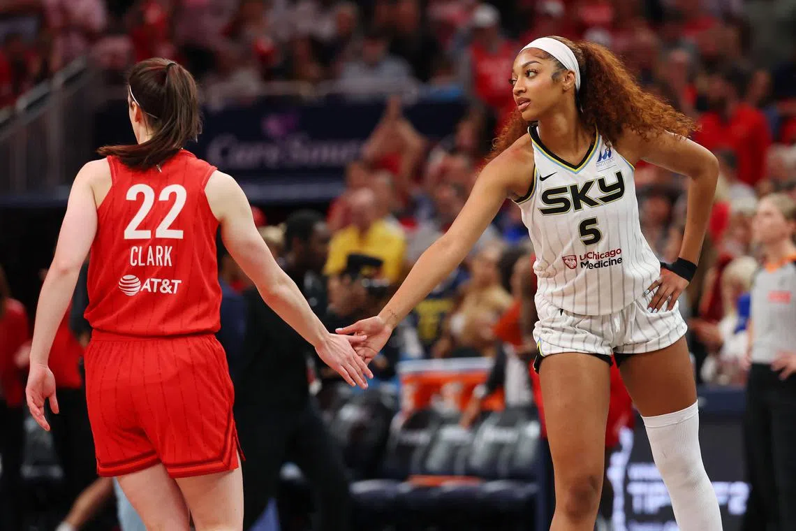 Angel Reese of the Chicago Sky and Caitlin Clark of the Indiana Fever meet at mid court prior to tipoff.