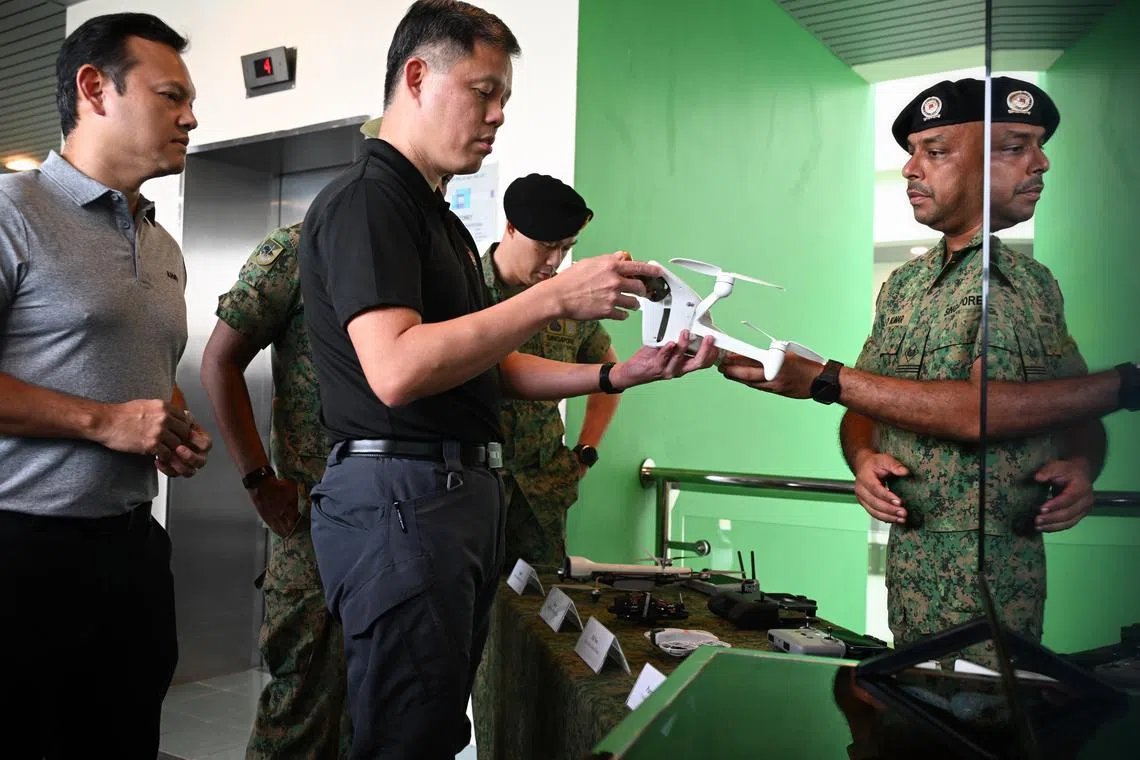 Singapore’s Defence Minister Chan Chun Sing is shown the different drones used by the SAF during his visit to the SAF Basic Military Training Centre at Pulau Tekong, on Aug 4.