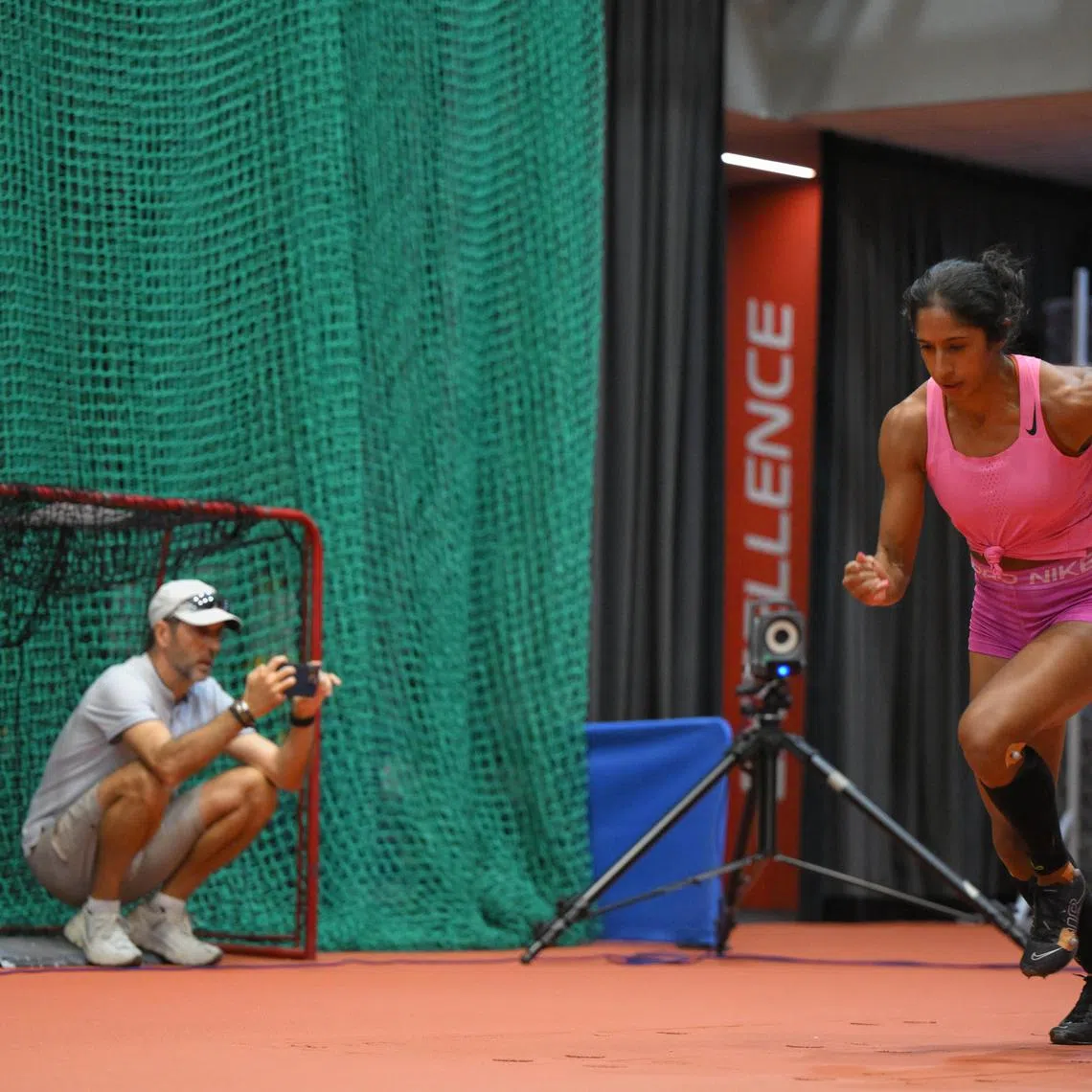 Coach Luis Cunha keeps a close eye on Shanti Pereira's technique during training. 