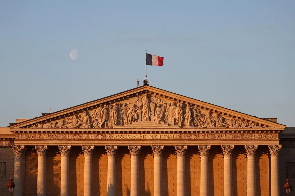 FILE PHOTO: A French flag flies over the National Assembly in Paris, France, April 18, 2025. REUTERS/Abdul Saboor/File Photo