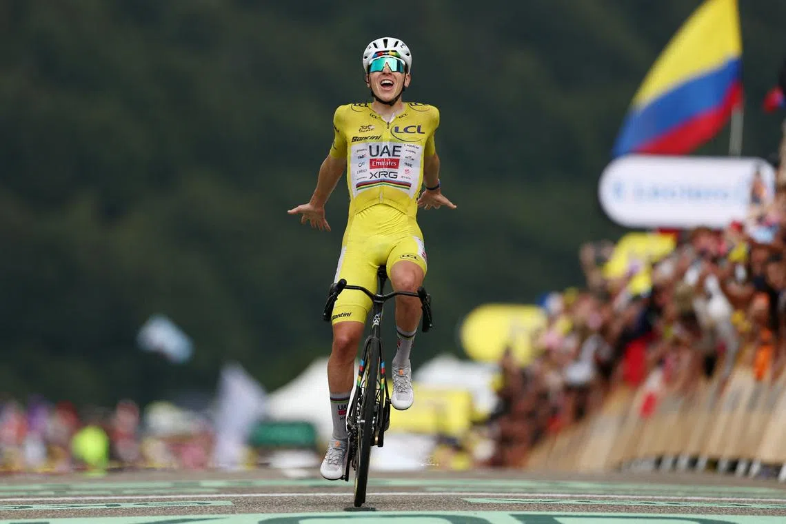 UAE Team Emirates XRG’s Tadej Pogacar, wearing the yellow jersey, celebrates after winning Stage 14 of the Tour de France on July 18.