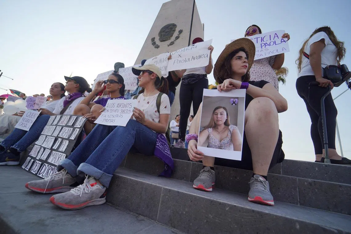 People hold photographs of Paola Banuelos, a 23-year-old woman who went missing days earlier after using the ride-hailing platform DiDi, while participating in demonstration to demand justice after authorities found her body in the border city of Mexicali, state of Baja California, Mexico  July 11, 2024. REUTERS/Víctor Medina