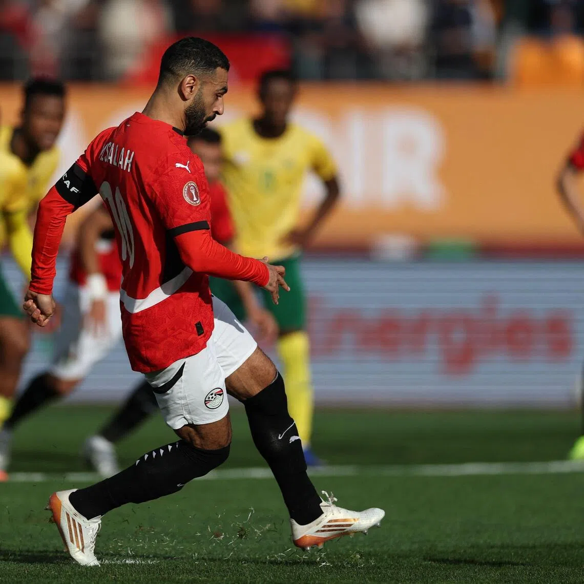Egypt's forward #10 Mohamed Salah shoots from the penalty spot to score the team's first goal during the Africa Cup of Nations (CAN) Group B football match between Egypt and South Africa at Adrar Stadium in Agadir on December 26, 2025. (Photo by FRANCK FIFE / AFP)