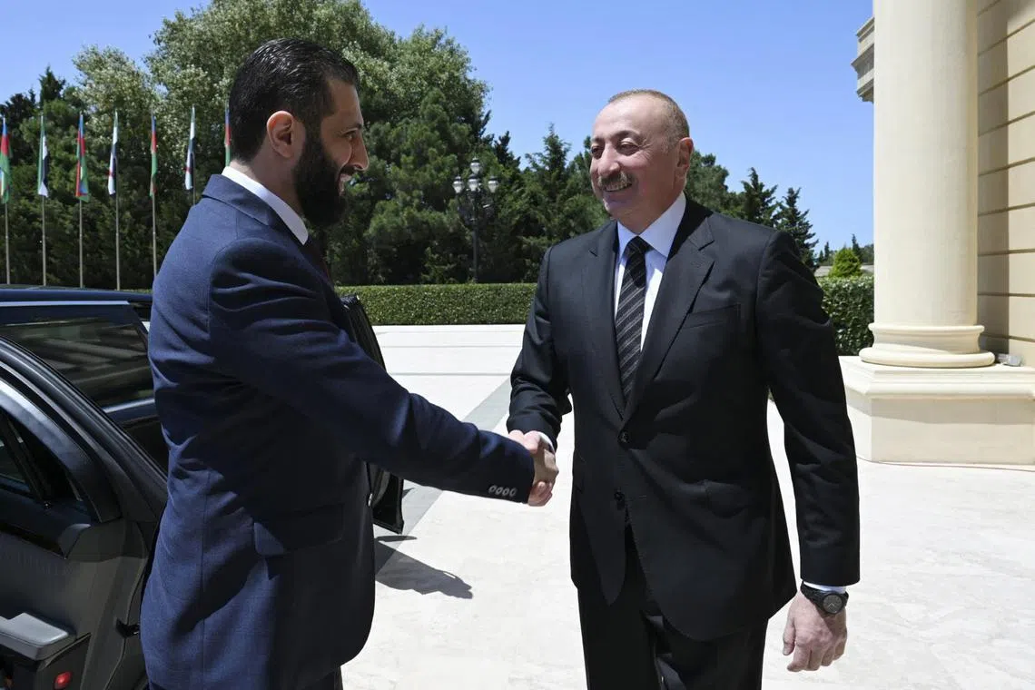 Azerbaijani President Ilham Aliyev (right) welcoming Syrian Interim President Ahmed al-Sharaa to Baku, Azerbaijan, on July 12.