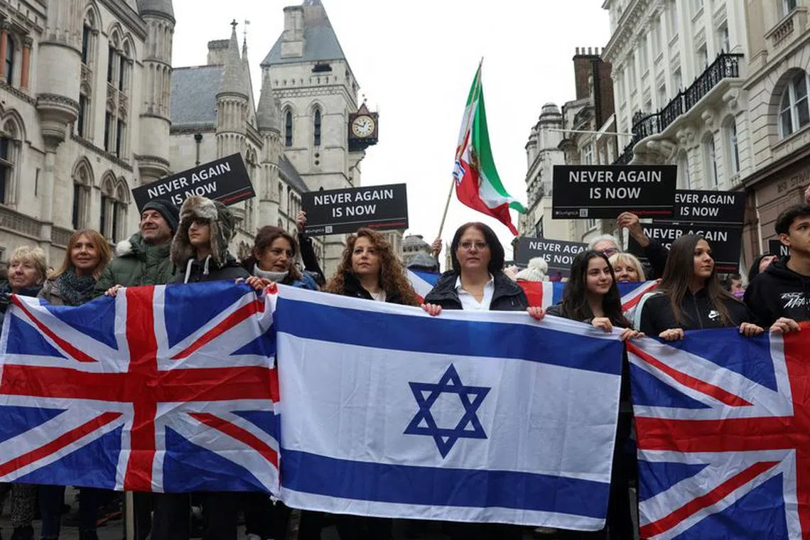 FILE PHOTO: People hold Israeli and British flags during a march against antisemitism, after an increase in the UK, during a temporary truce between the Palestinian Islamist group Hamas and Israel, in London, Britain November 26, 2023. REUTERS/Susannah Ireland/File Photo