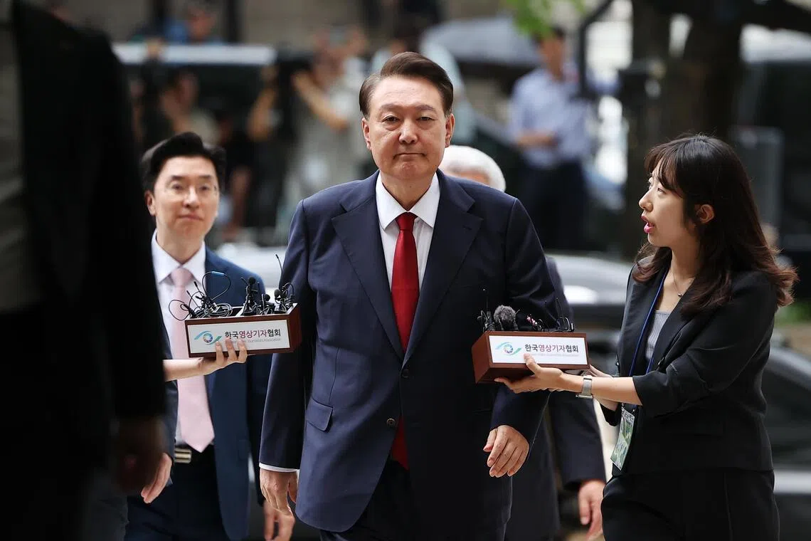 Former South Korean president Yoon Suk Yeol (centre) imposed a brief martial law in December 2024, during which he banned all political activities and placed the news media under military control.