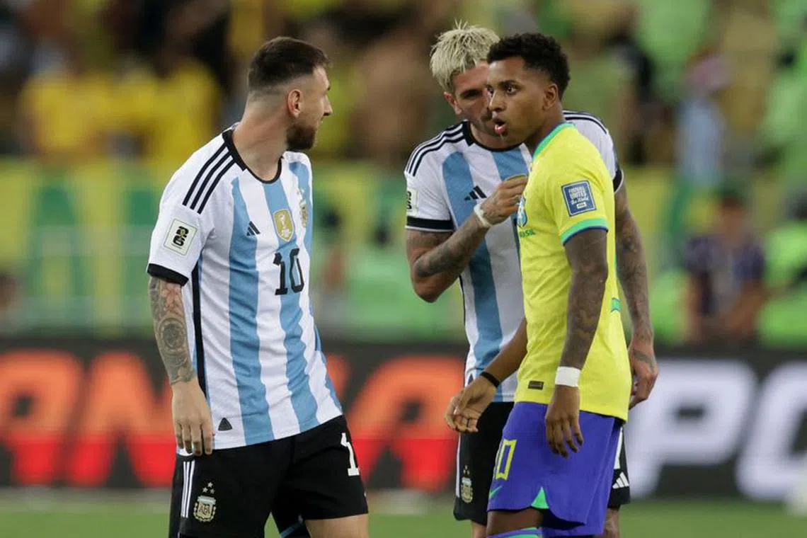 Soccer Football - World Cup - South American Qualifiers - Brazil v Argentina - Estadio Maracana, Rio de Janeiro, Brazil - November 21, 2023 Argentina's Lionel Messi and Brazil's Rodrygo clash before the delayed start of the match REUTERS/Ricardo Moraes