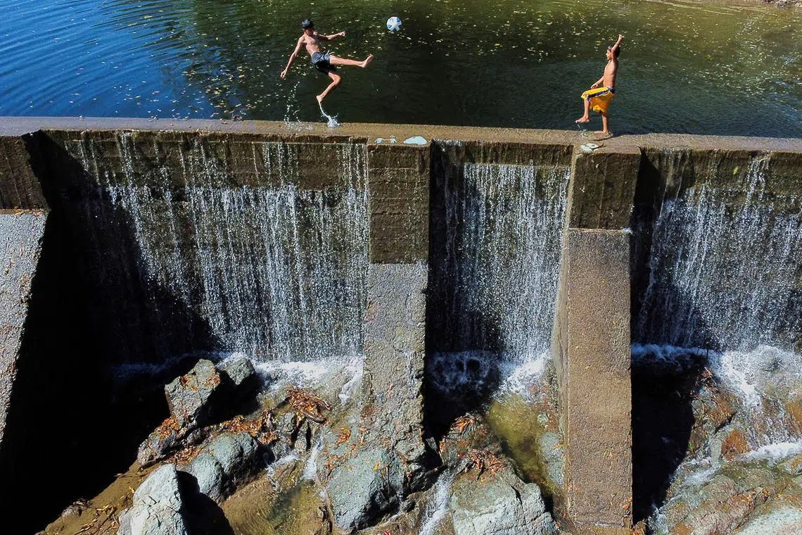 Children playing on a dam built by a mining company at the San Sebastian gold mine area in Santa Rosa de Lima, El Salvador, Dec 17, 2024. 