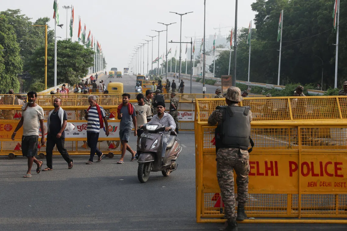 Police officers standing guard at a protest seeking the resignation of India’s chief election commissioner, Gyanesh Kumar, in New Delhi, on Oct 11.