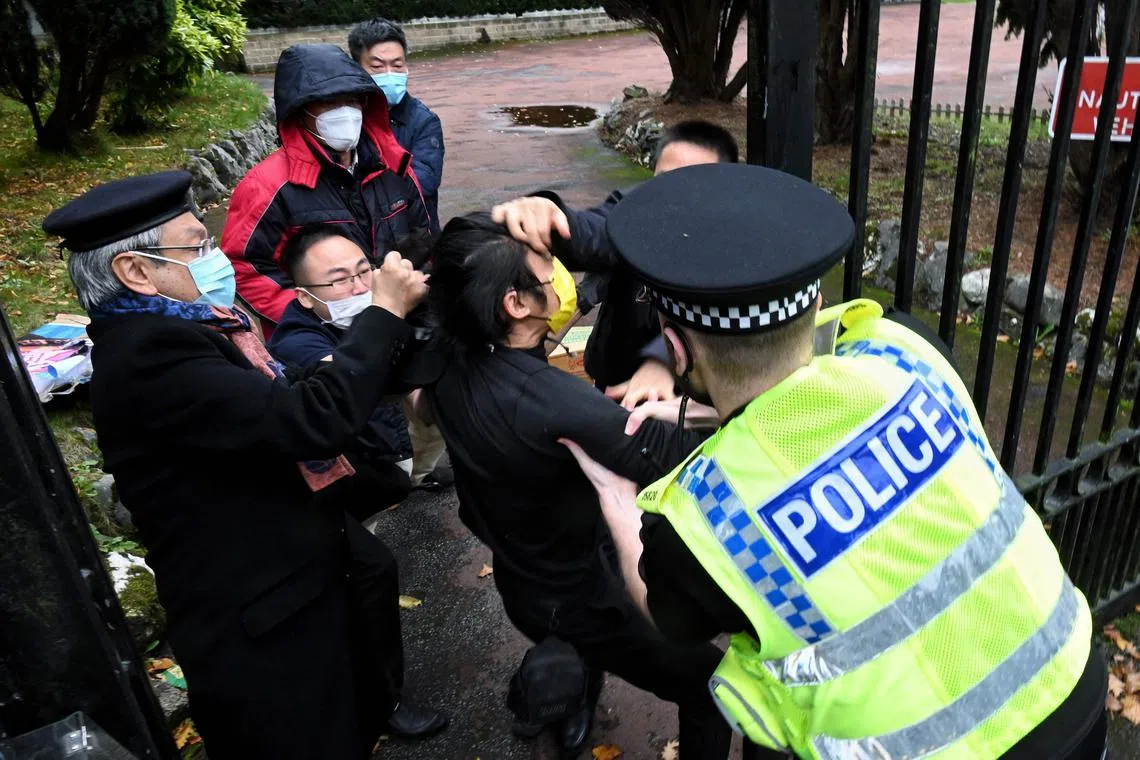 A file photo taken on Oct 16, 2022 shows an incident involving a scuffle between a Hong Kong pro-democracy protester (C) and Chinese consulate staff, as a British police officer attempts to intervene, during a demonstration outside the consulate in Manchester. 