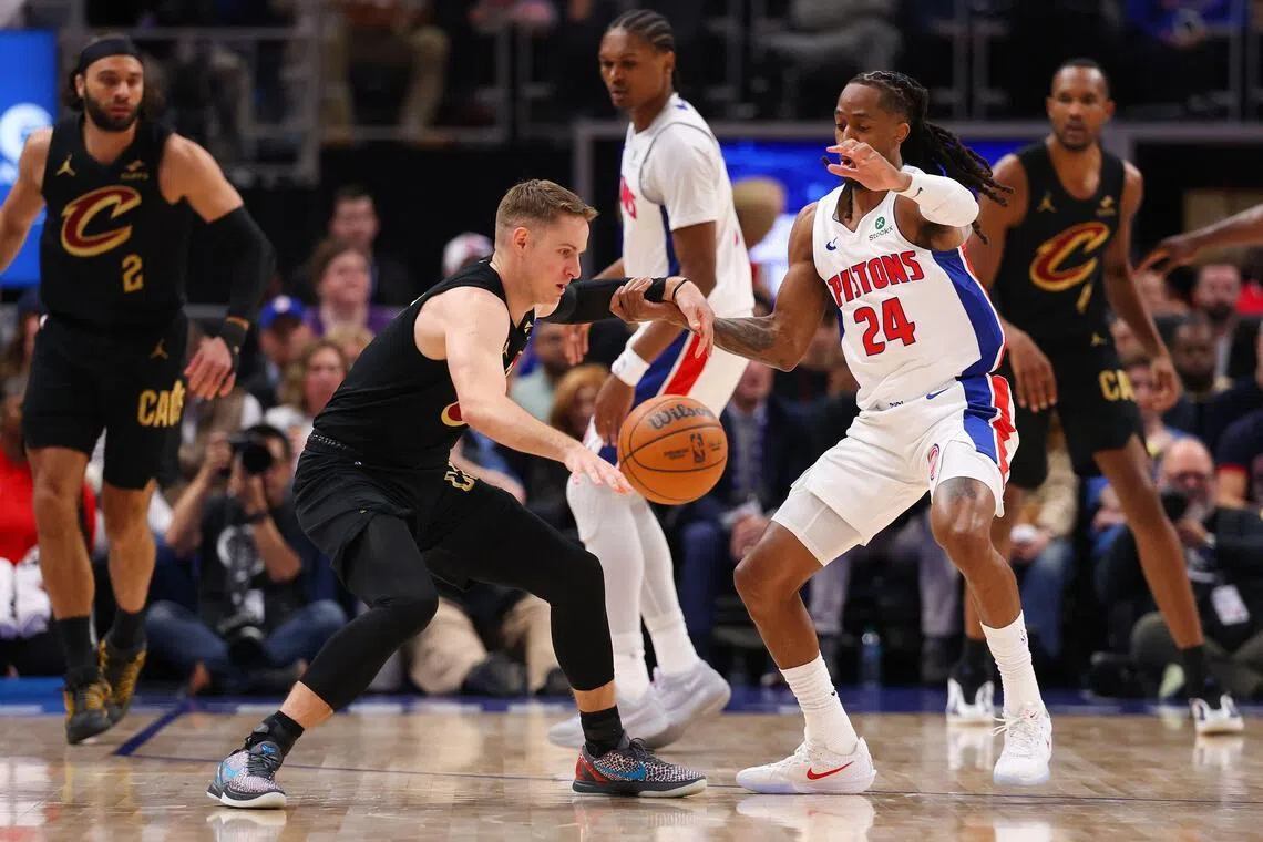 Sam Merrill of the Cleveland Cavaliers works against Daniss Jenkins of the Detroit Pistons during the first quarter in Game 1.