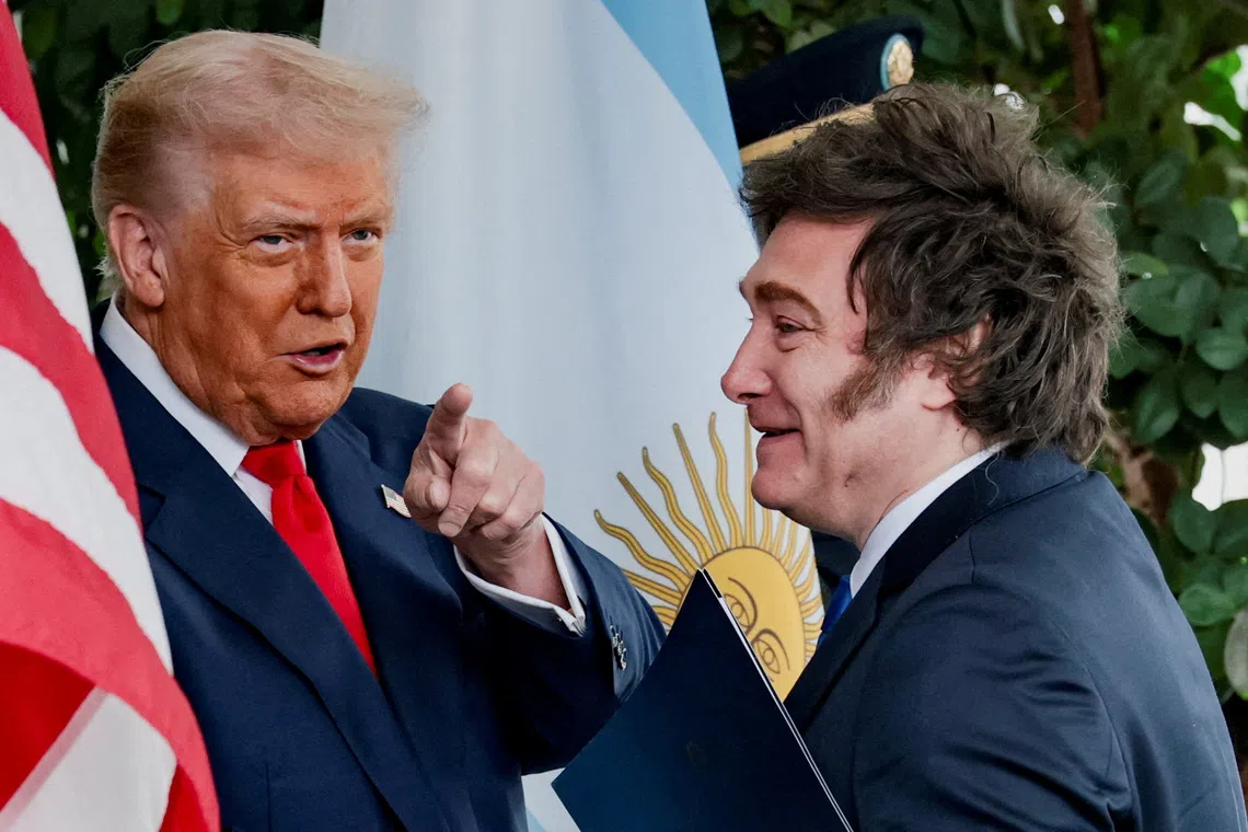 U.S. President Donald Trump points a finger as he welcomes Argentina's President Javier Milei at the White House in Washington, D.C., U.S., October 14, 2025. REUTERS/Jonathan Ernst