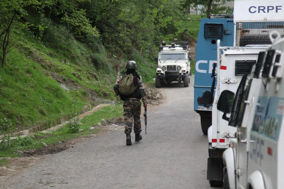 FILE PHOTO: An Indian security force trooper moves past parked vehicles during a cordon and search operation, following an attack on tourists near Pahalgam, in Gudder village of south Kashmir's Kulgam district April 26, 2025. REUTERS/Stringer/File Photo
