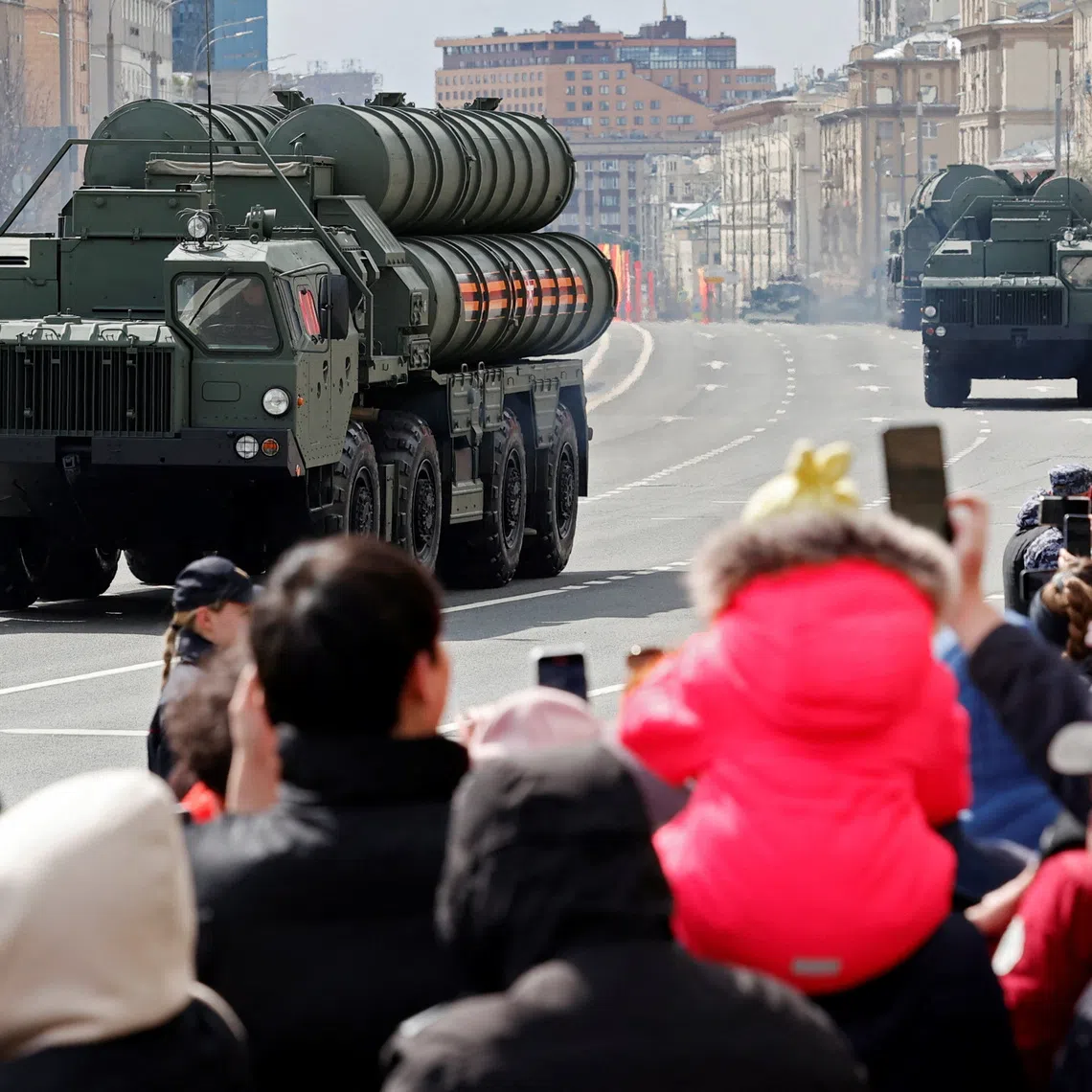Spectators watch Russia's S-400 air defence system units driving along a road after a military parade on Victory Day, which marks the 79th anniversary of the victory over Nazi Germany in World War Two, in Moscow, Russia, May 9, 2024. REUTERS/Yulia Morozova