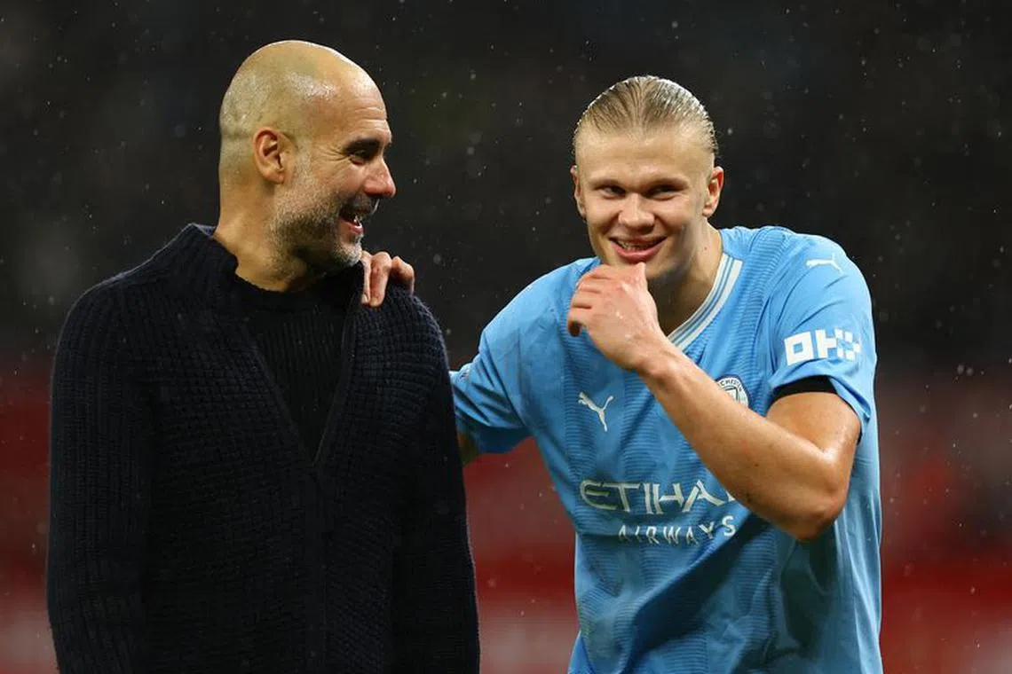 Soccer Football - Premier League - Manchester United v Manchester City - Old Trafford, Manchester, Britain - October 29, 2023   Manchester City's Erling Braut Haaland celebrates with manager Pep Guardiola after the match REUTERS/Molly Darlington NO USE WITH UNAUTHORIZED AUDIO, VIDEO, DATA, FIXTURE LISTS, CLUB/LEAGUE LOGOS OR 'LIVE' SERVICES. ONLINE IN-MATCH USE LIMITED TO 45 IMAGES, NO VIDEO EMULATION. NO USE IN BETTING, GAMES OR SINGLE CLUB/LEAGUE/PLAYER PUBLICATIONS.