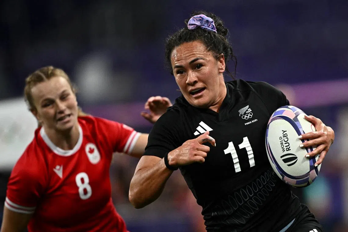 FILE PHOTO: Paris 2024 Olympics - Rugby Sevens - Women's Pool A - New Zealand vs Canada - Stade de France, Saint-Denis, France - July 28, 2024. Portia Woodman-Wickliffe of New Zealand in action with Carissa Norsten of Canada REUTERS/Dylan Martinez/File Photo