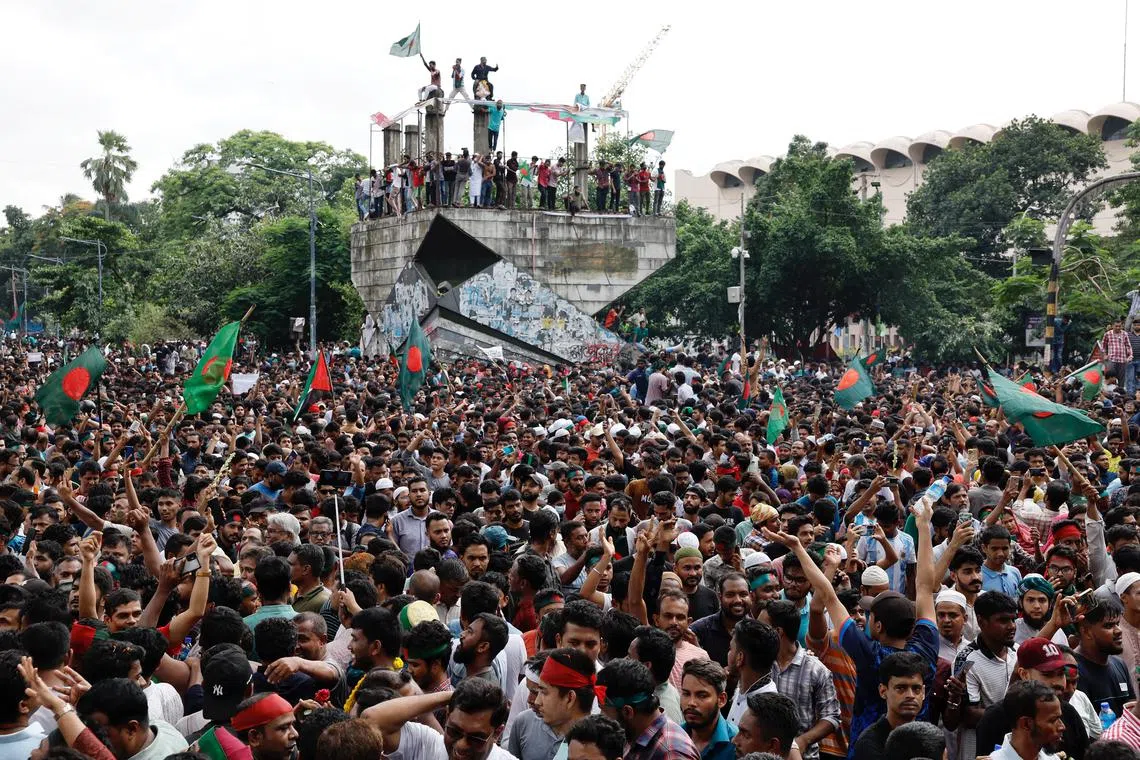 People celebrate the resignation of Bangladeshi Prime Minister Sheikh Hasina in Dhaka, Bangladesh, on Aug 5.