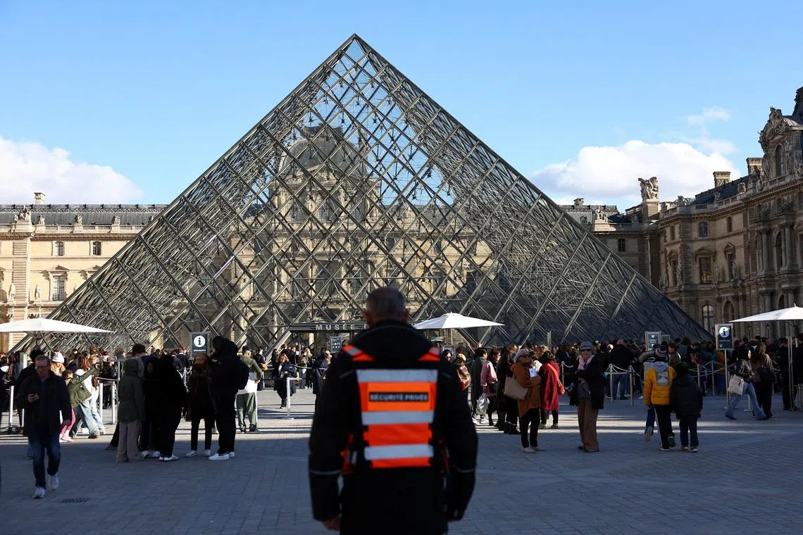 A member of security stands outside the Louvre Museum, after French police arrested suspects in the Louvre heist case, in Paris, France October 26, 2025. REUTERS/Abdul Saboor