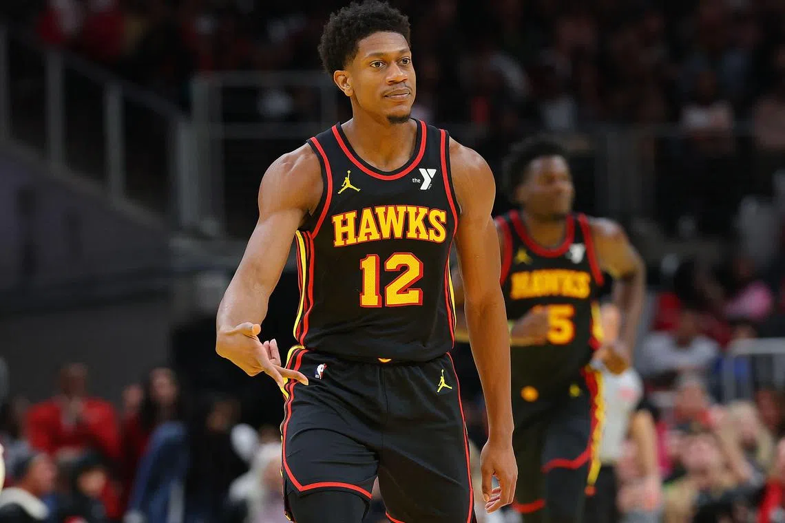 De'Andre Hunter of the Atlanta Hawks reacts after a three-point basket against the Cleveland Cavaliers during the third quarter at State Farm Arena.