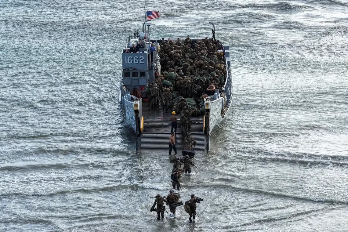 U.S. Marines wading ashore after disembarking from a U.S. Navy Landing Craft Utility (LCU), during amphibious operations in Arroyo, Puerto Rico, on Dec 9, 2025. 