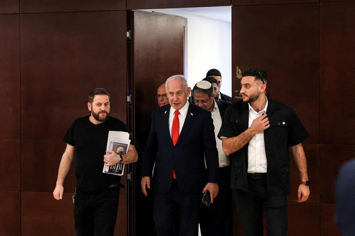 FILE PHOTO: Israeli Prime Minister Benjamin Netanyahu followed by National Security Minister Itamar Ben-Gvir walk inside the Israeli parliament, the Knesset, in Jerusalem March 27, 2025. REUTERS/Ronen Zvulun/File Photo