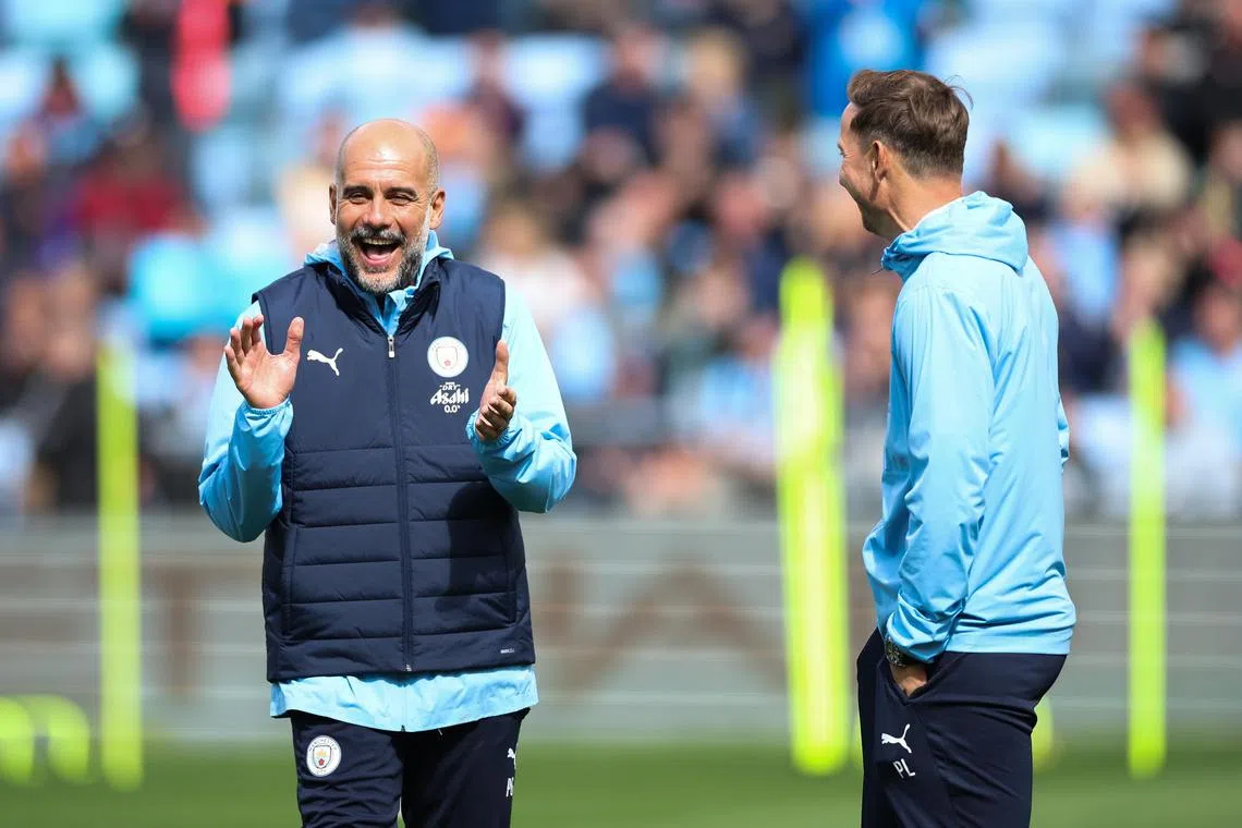 Manchester City manager Pep Guardiola (left) and assistant manager Pep Lijnders (right) taking part in an open training session during a season launch event in Manchester on Aug 5.