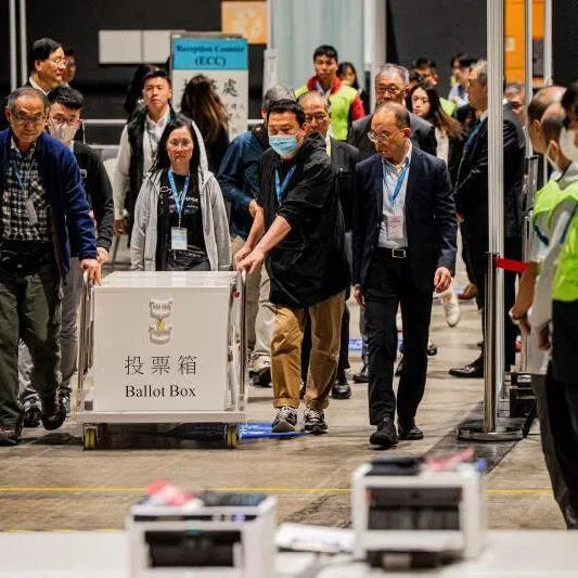 The first ballot box being delivered to the counting station after polls closed in the Legislative Council elections in Hong Kong, on Dec 7.