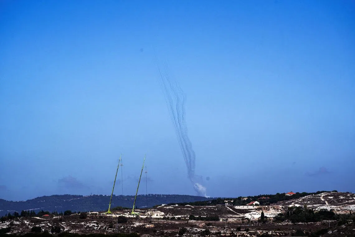 Rockets are launched from Lebanon towards Israel, amid cross-border hostilities between Hezbollah and Israel, as seen from northern Israel, October 8, 2024. REUTERS/Ayal Margolin