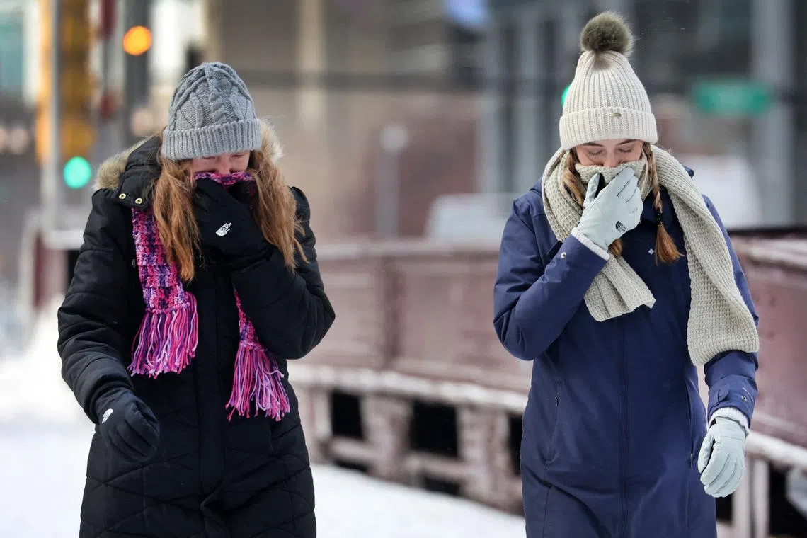 Pedestrians cross a bridge over the Chicago River in downtown as temperatures hover in the negative single-digits on December 23, 2022 in Chicago, Illinois. Sub-zero temperatures combined with strong winds are expected to grip the city for the next couple of days with wind chill temperature dipping as low as -40 degrees. 
