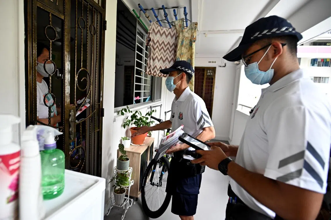 Community policing officers making home visits to educate residents about scams in March 2021.