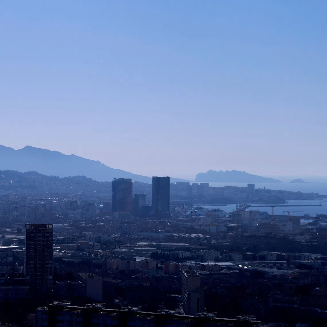 FILE PHOTO: A general view shows residential apartment buildings, the harbor towers and the Marseille skyline with Notre-Dame de la Garde Basilica in the background, Marseille, France, January 14, 2025. REUTERS/Manon Cruz/File Photo