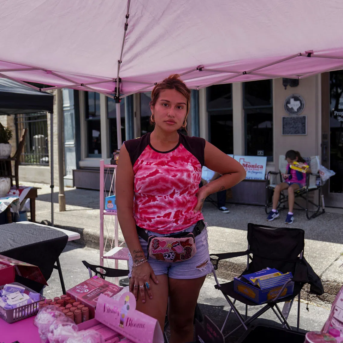 Valencia Macias, 26, poses for a photo during a market day in Beeville, Texas, U.S. August 1, 2026.  REUTERS/Gabriel V. Cardenas