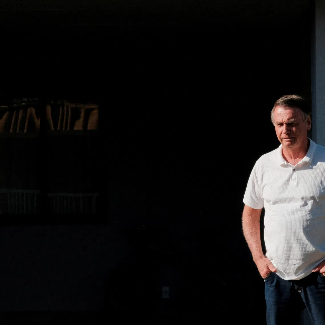 FILE PHOTO: Brazil’s former President Jair Bolsonaro looks on from his home as Sao Paulo’s Governor Tarcisio de Freitas (not pictured) leaves after a visit in Brasilia, Brazil September 29, 2025. REUTERS/Diego Herculano/File Photo